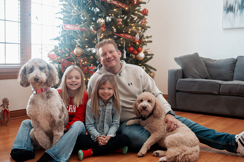 family1 Derrick and his kids and dogs in front of the Christmas tree