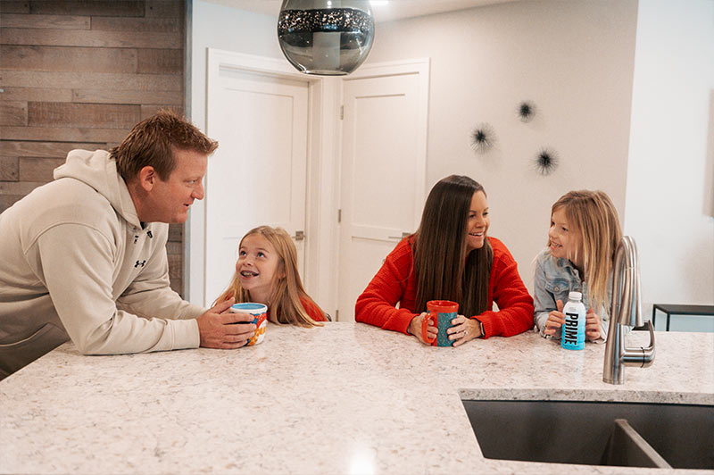 family2 The Kunz family sitting at the bar in the kitchen